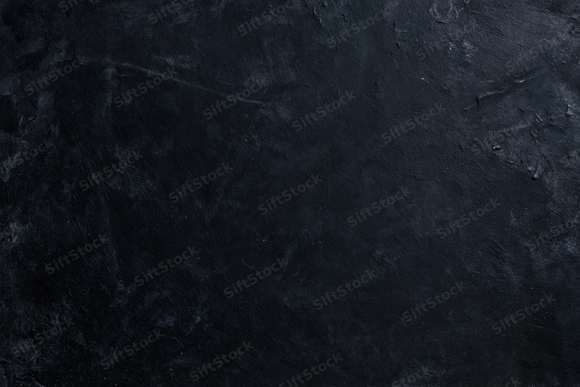 Dark weathered concrete wall surface with rough texture and subtle cracks filling the frame