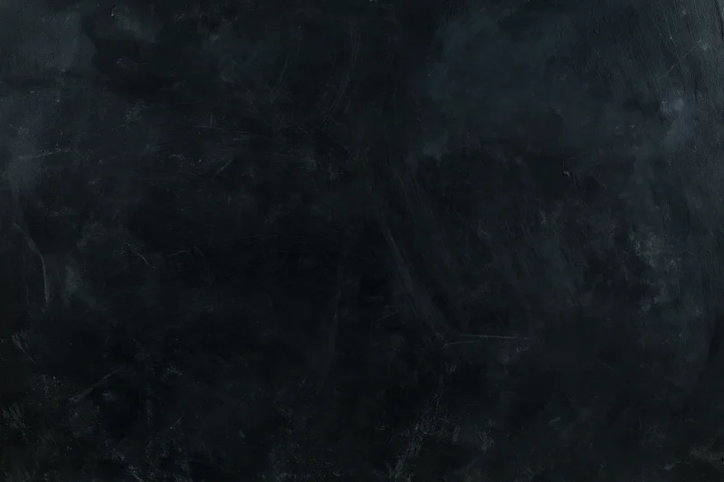 Dark weathered concrete wall surface with textured grunge pattern