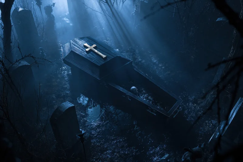 Open dark wooden coffin with gold cross in misty graveyard at night
