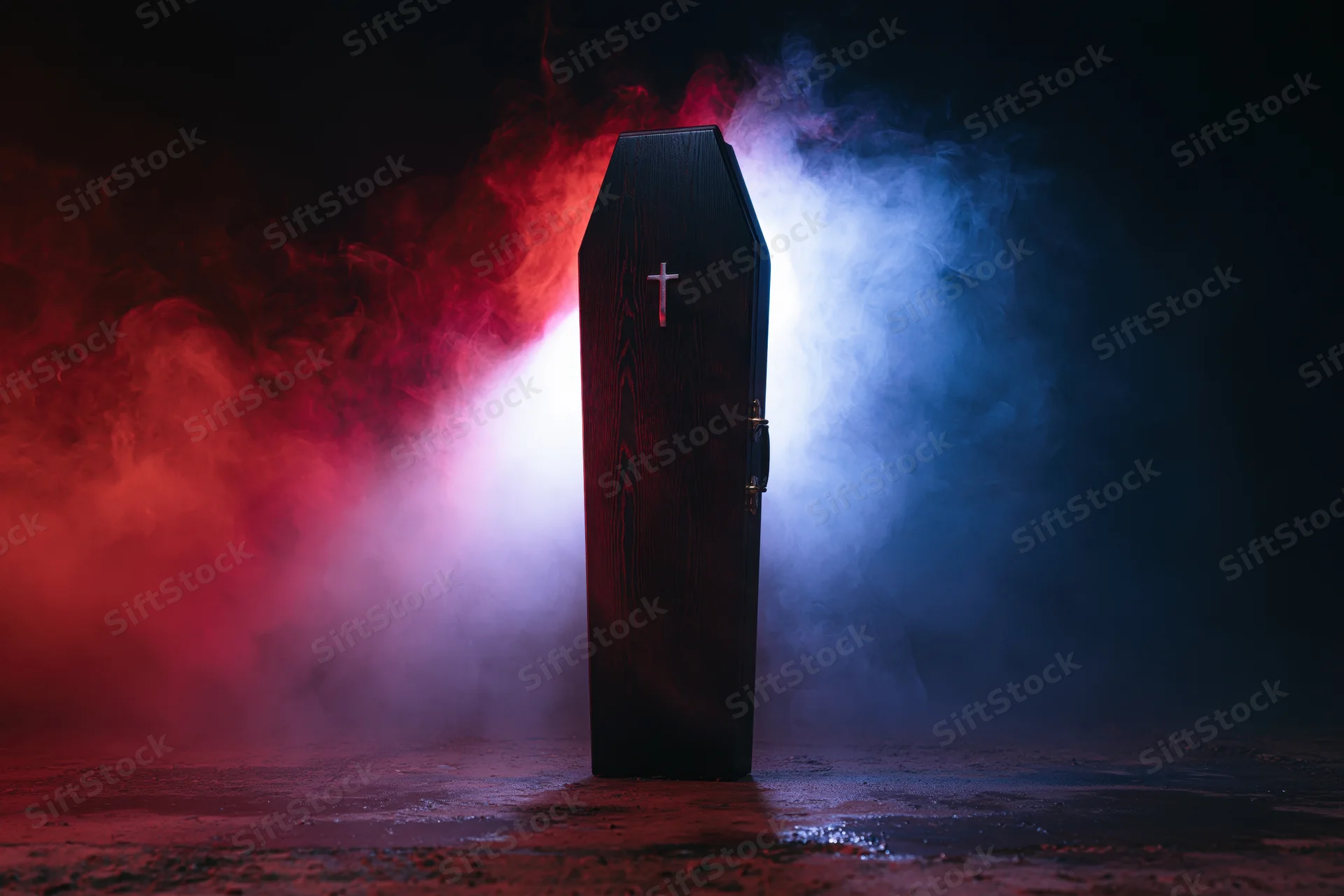 Dark wooden coffin with silver cross standing upright in smoky red and blue light