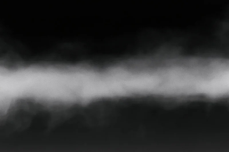 Dense white fog rolling horizontally across the frame forming a soft atmospheric band