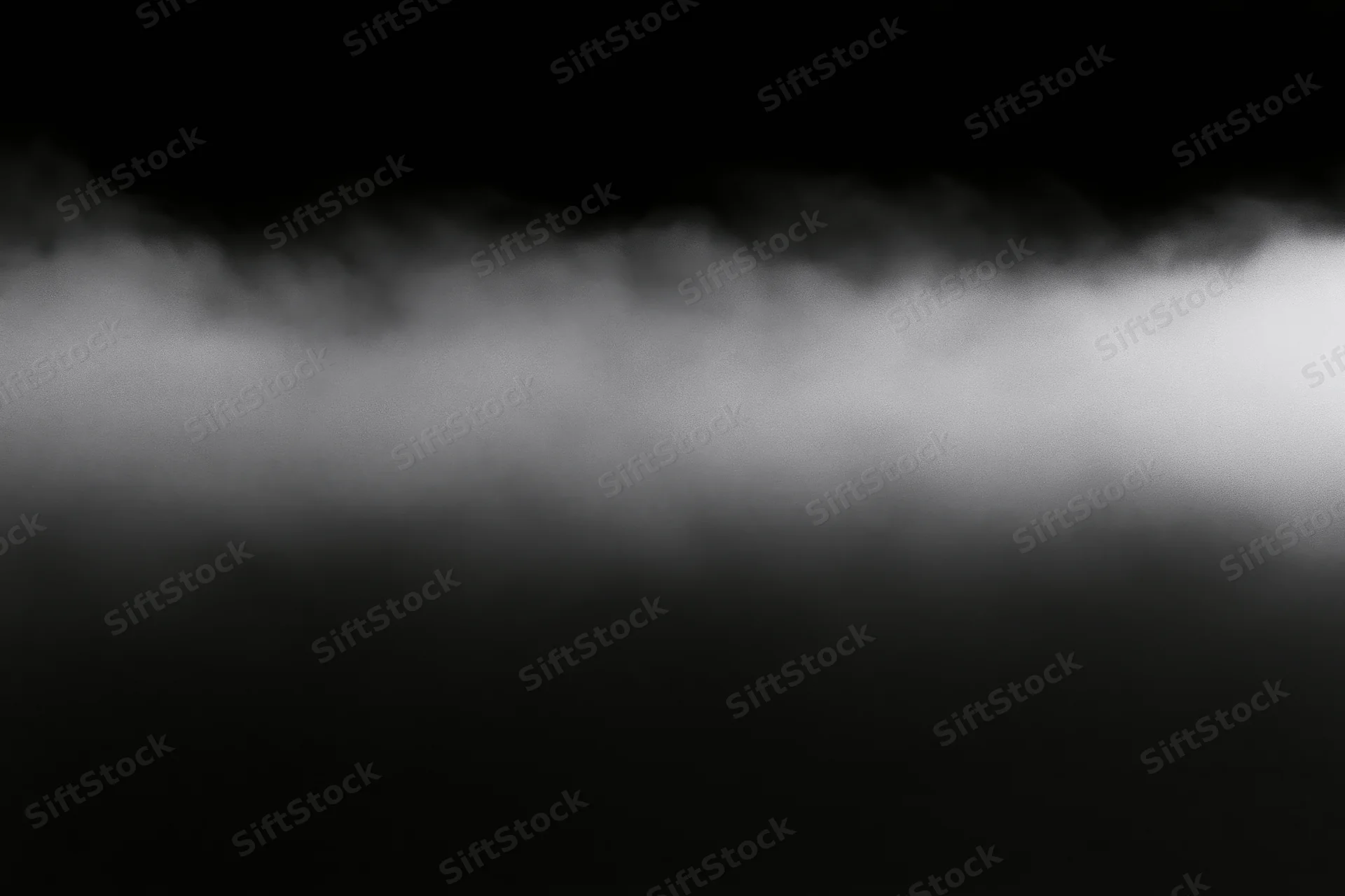 Dense white fog rolling horizontally across the frame forming a soft gradient band against dark background