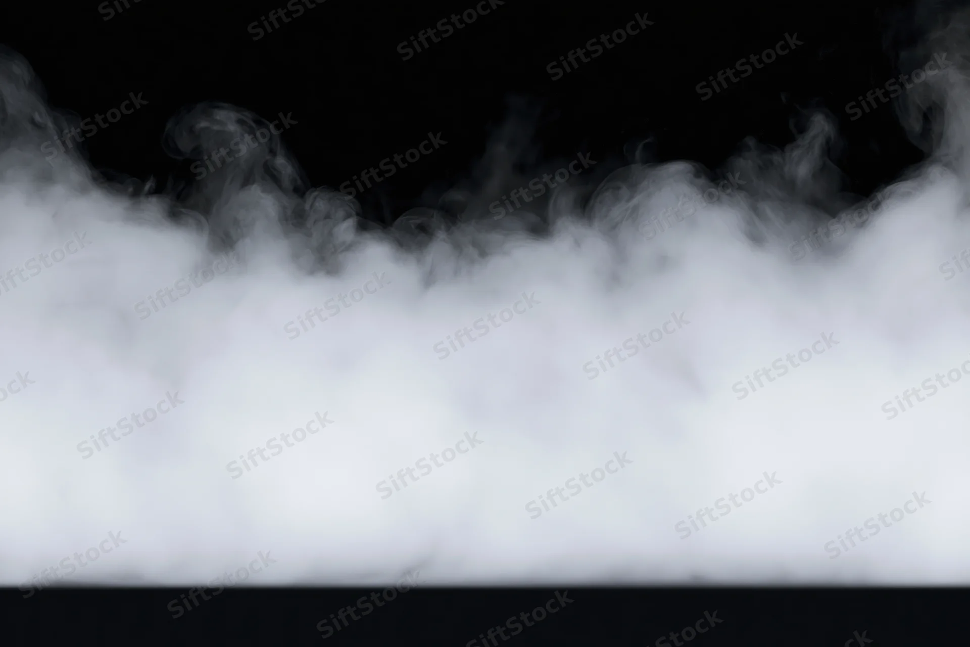 Dense white smoke drifting horizontally across black background