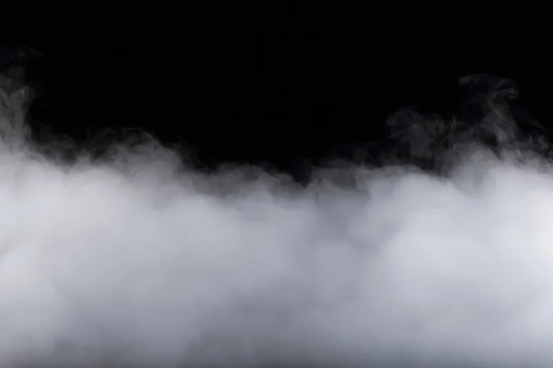 Dense white smoke drifting horizontally across black background