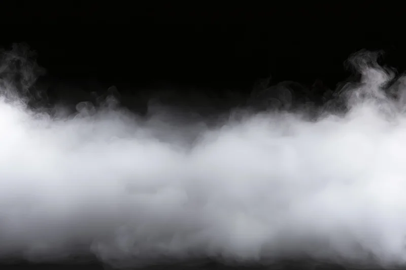 Dense white smoke drifting horizontally across black background