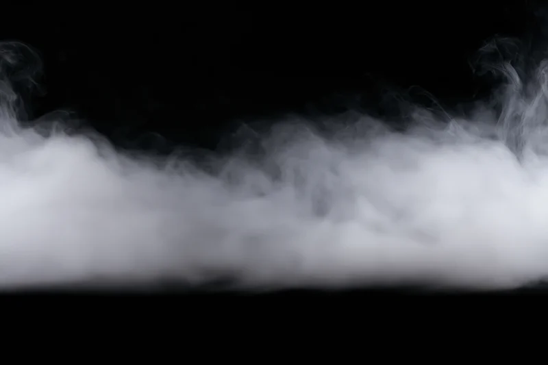 Dense white smoke drifting horizontally across black background