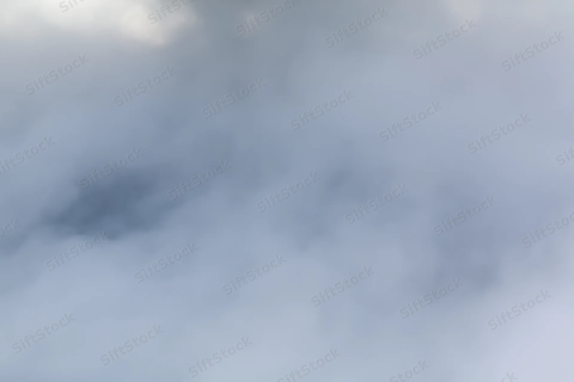 Dense white steam billowing across a flat surface in a hazy outdoor environment