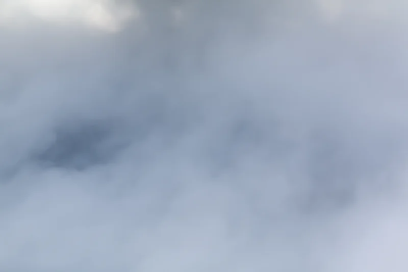 Dense white steam billowing across a flat surface in a hazy outdoor environment