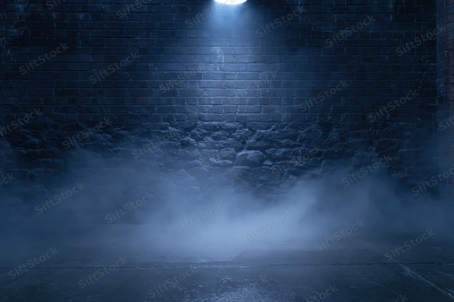 Spotlight on a weathered brick wall in a dark urban room with fog on the concrete floor