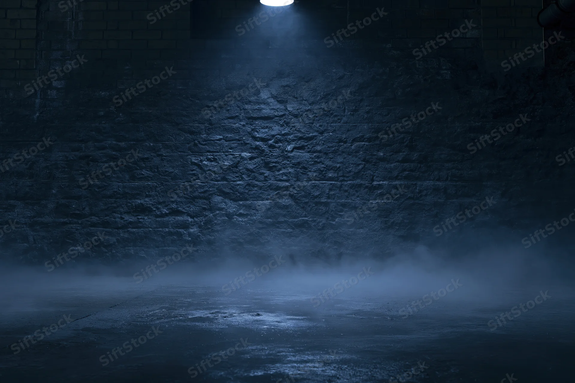 Spotlight on a weathered brick wall in a dark urban room with fog on the concrete floor