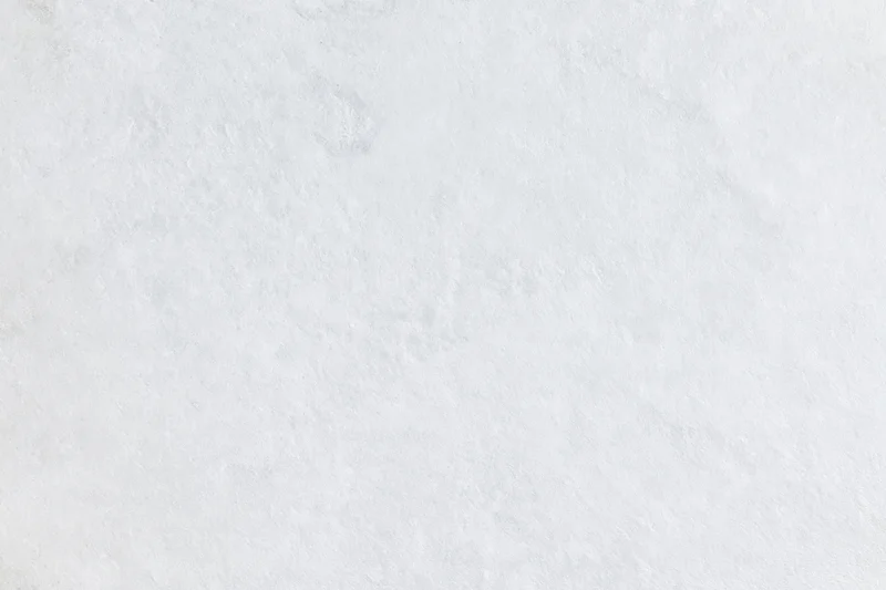 Close-up of a plain white frosted surface with subtle texture