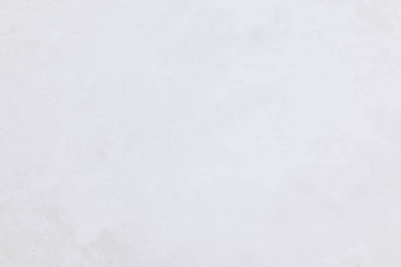Close-up of a plain white frosted surface with subtle texture