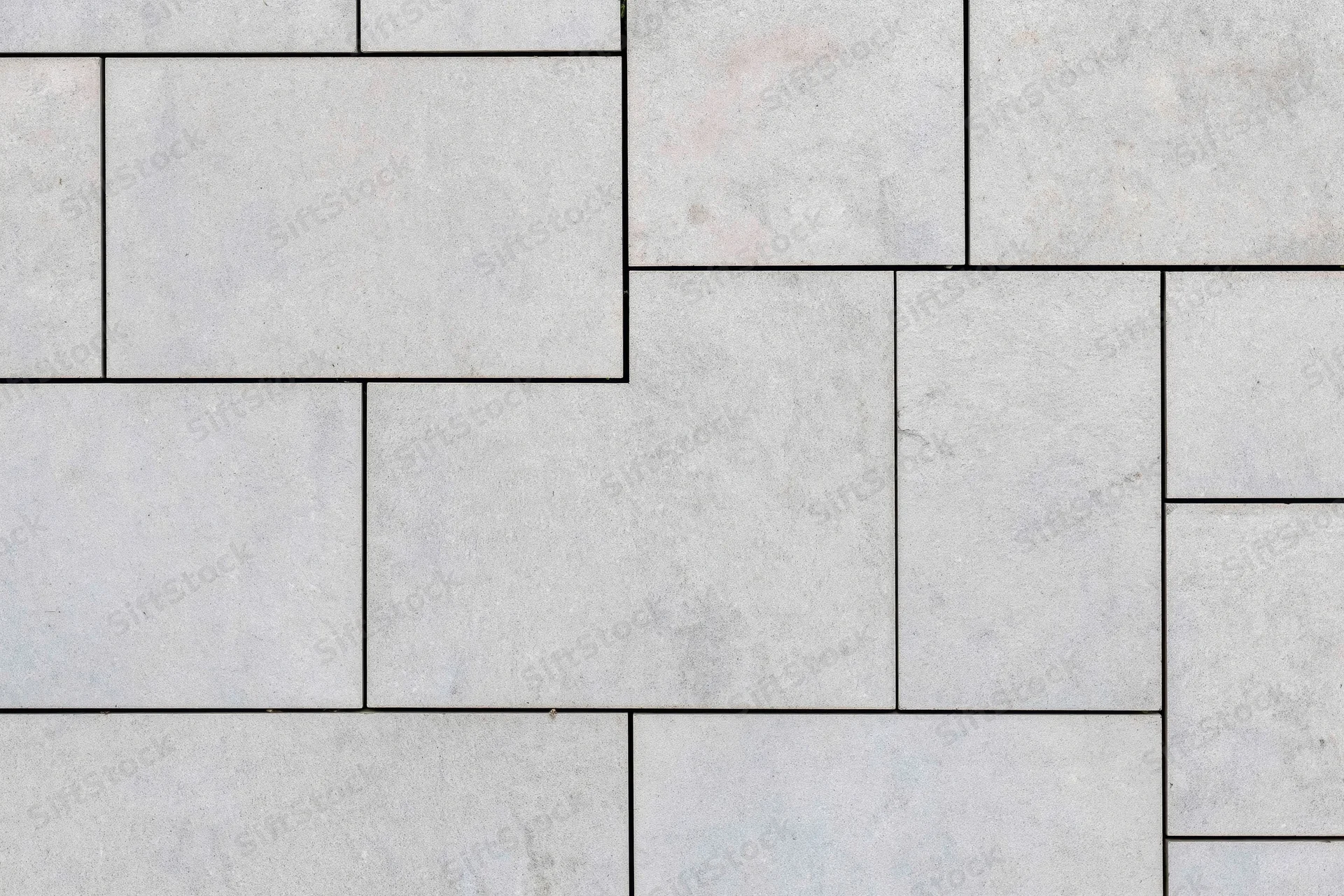 Overhead view of gray concrete pavers arranged in a geometric pattern for an outdoor walkway