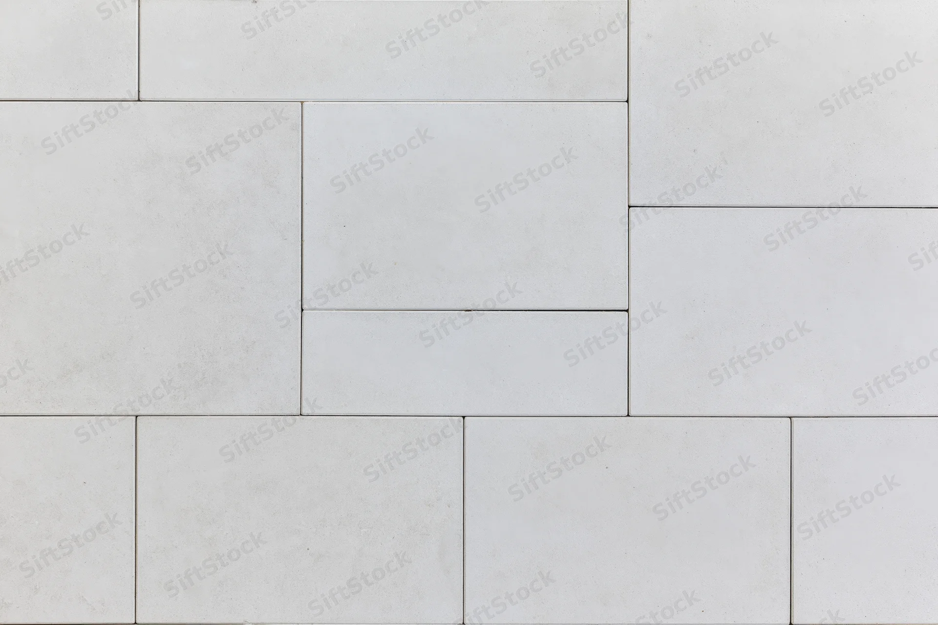 Light grey concrete paving slabs arranged in a geometric pattern for outdoor flooring
