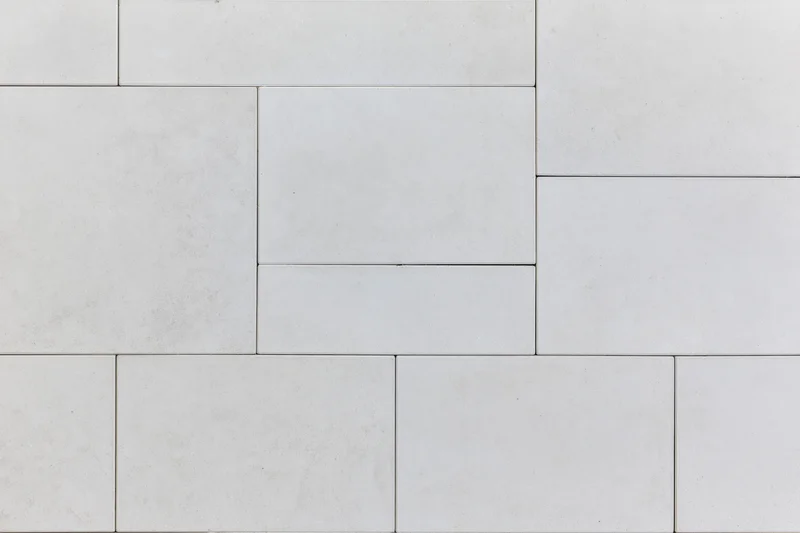 Light grey concrete paving slabs arranged in a geometric pattern for outdoor flooring