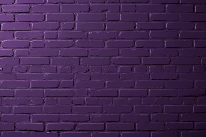 Purple painted brick wall filling the frame as a textured background