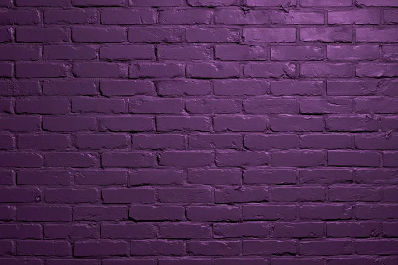 Purple painted brick wall filling the frame as a textured background