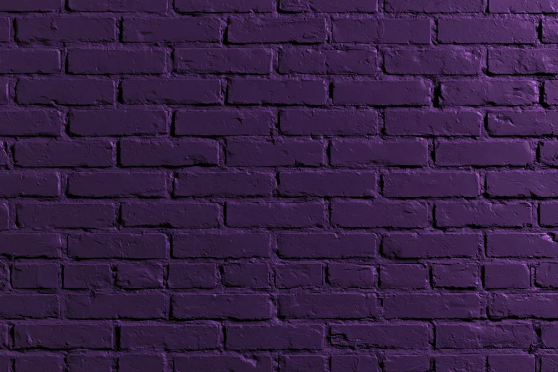 Purple painted brick wall filling the frame as a textured background
