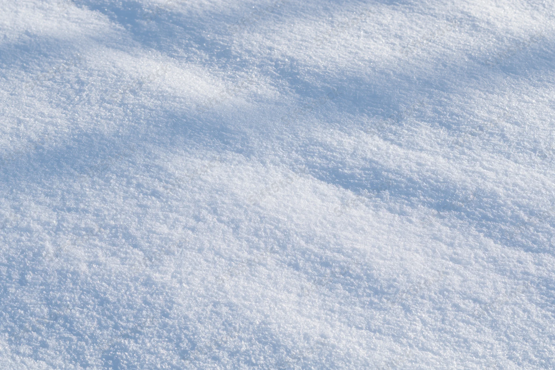 Undisturbed snow surface filling the frame with soft shadows and texture