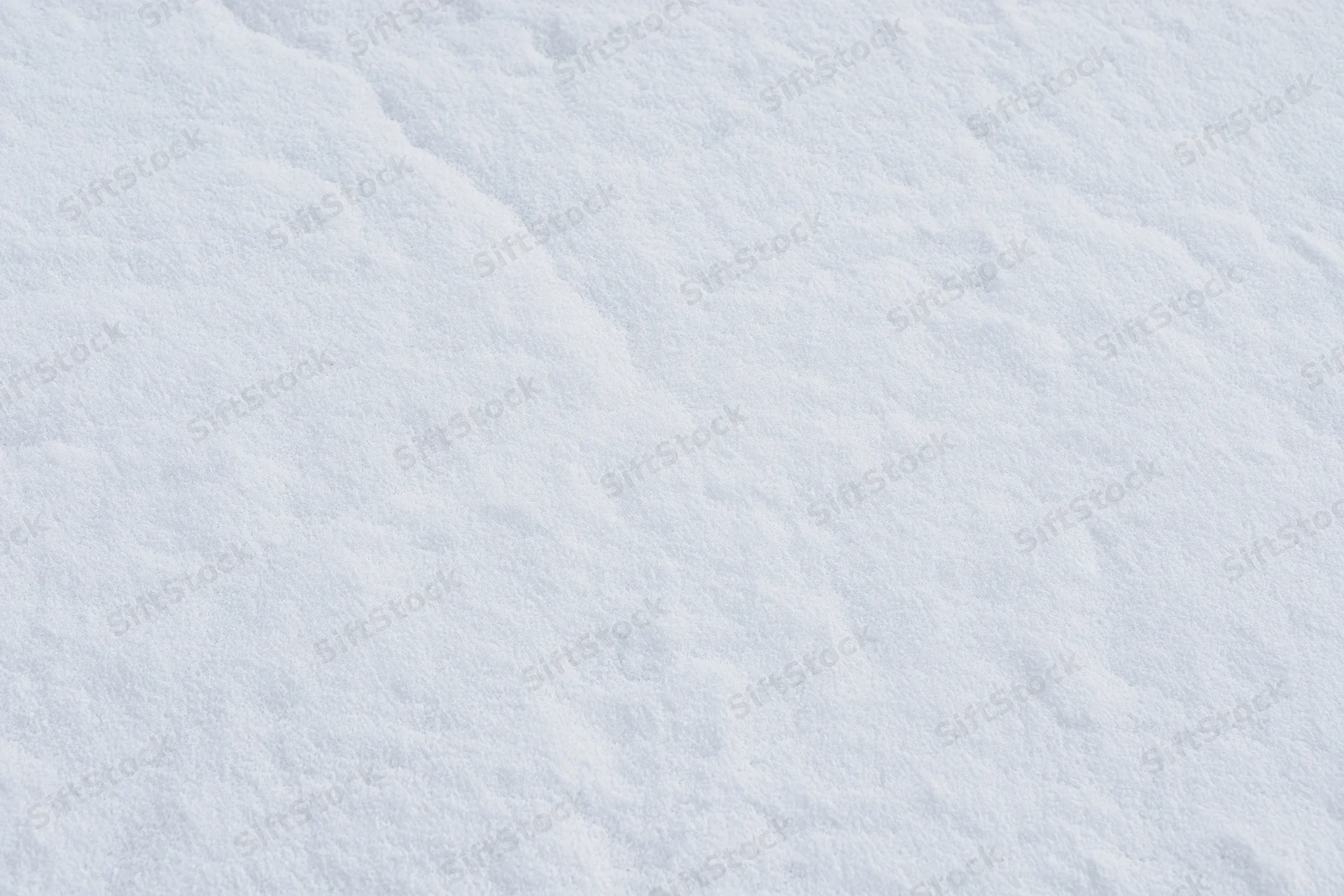 Close-up of undisturbed snow surface covering the ground