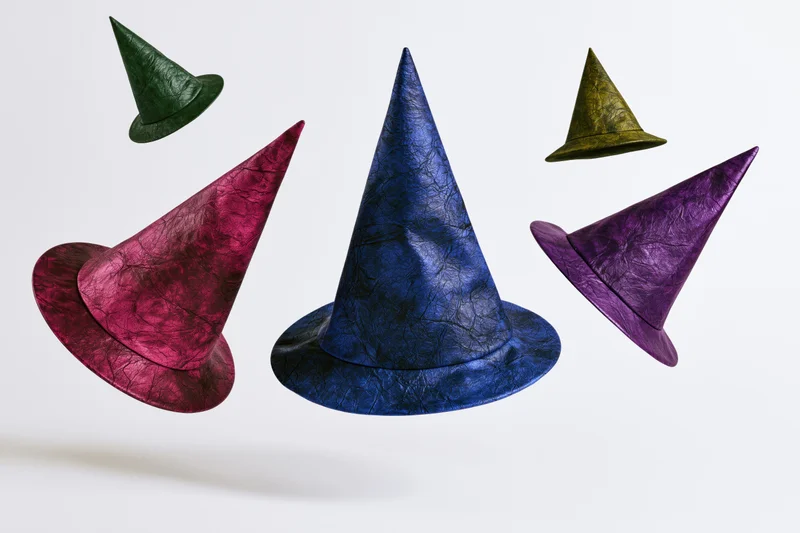 Five witch hats floating in midair against a white background