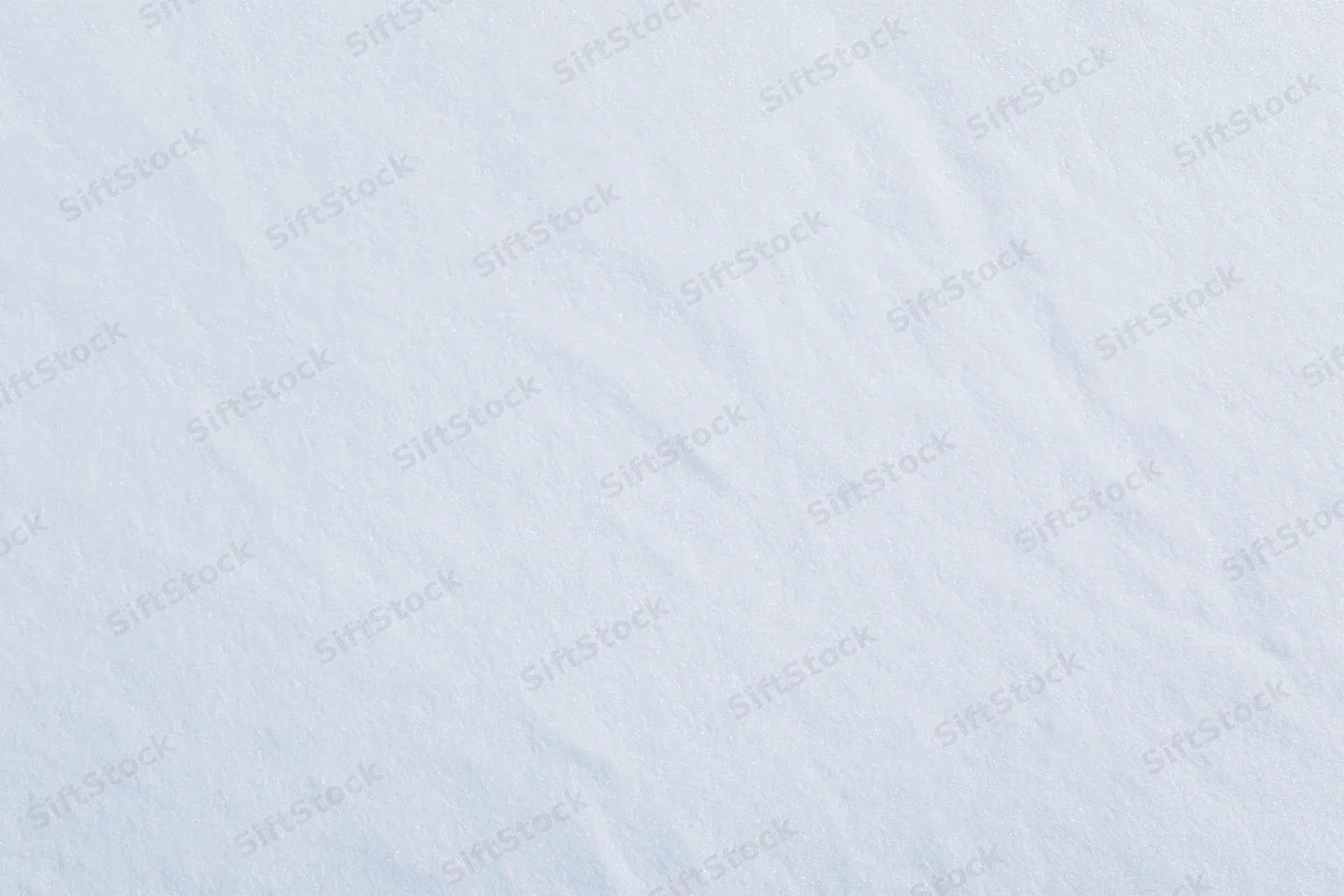 Fresh snow surface filling the frame from overhead view