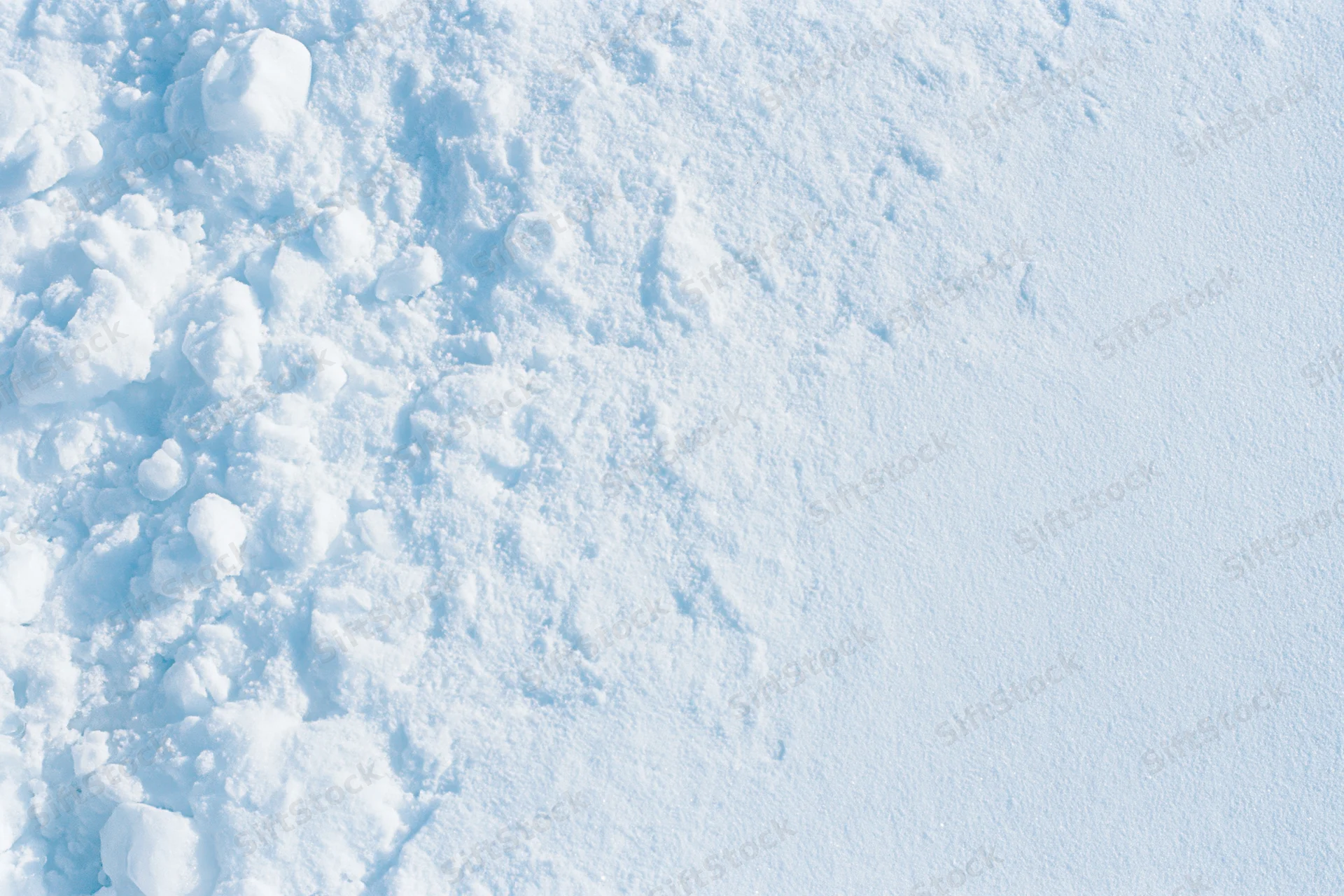Close-up of snow surface texture with compacted and loose areas showing natural winter pattern