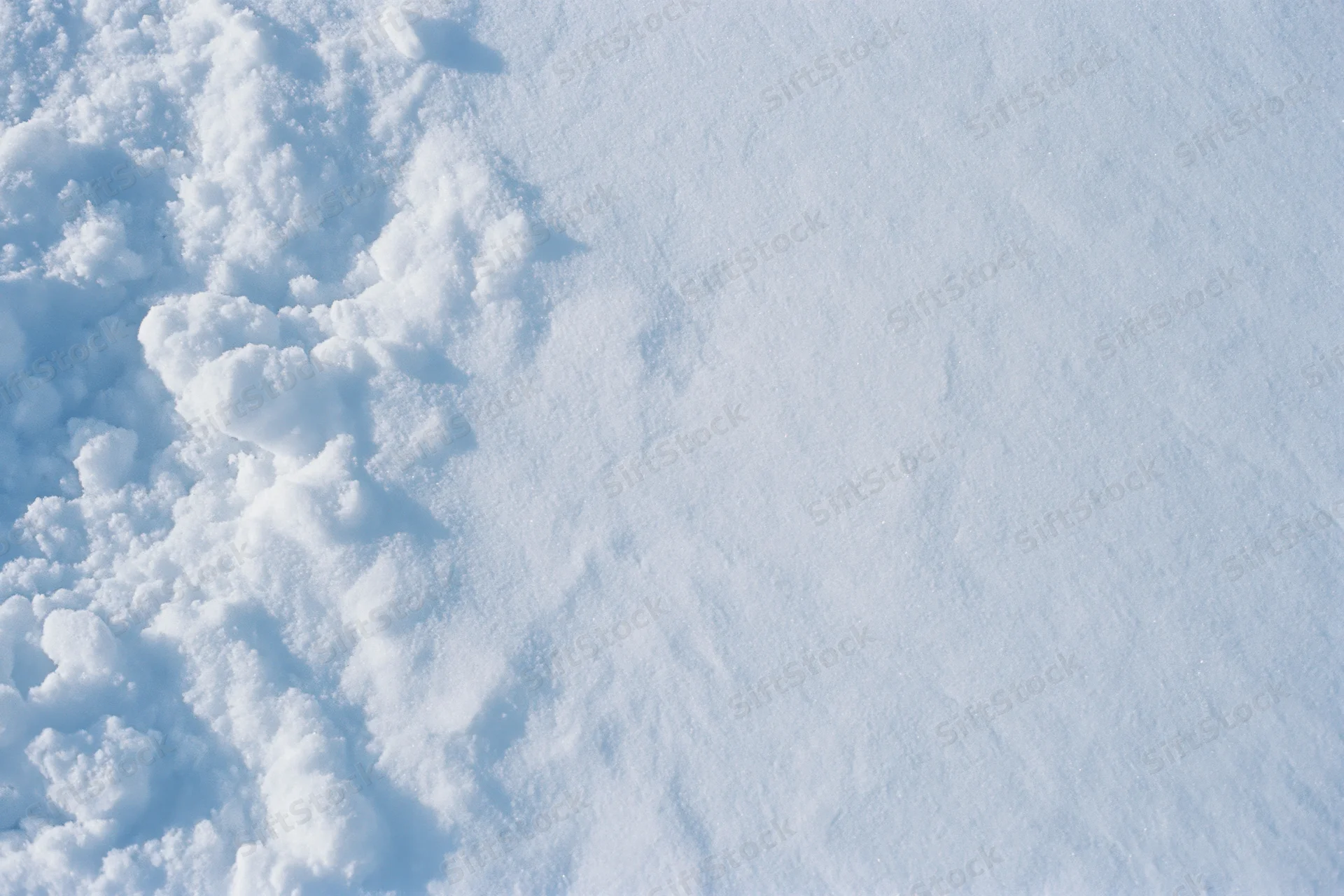 Close-up of fresh snow surface texture from above