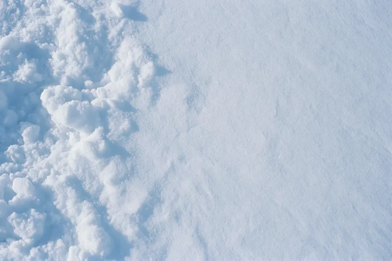 Close-up of fresh snow surface texture from above