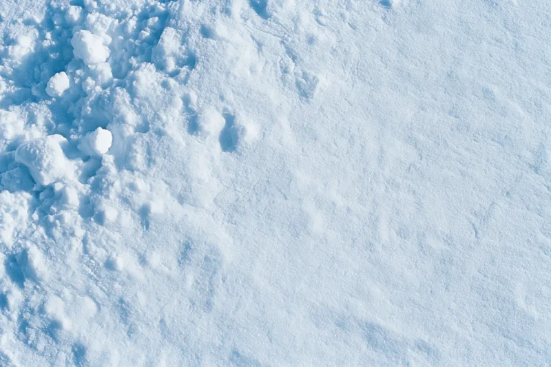 Close-up of fresh snow surface texture from above