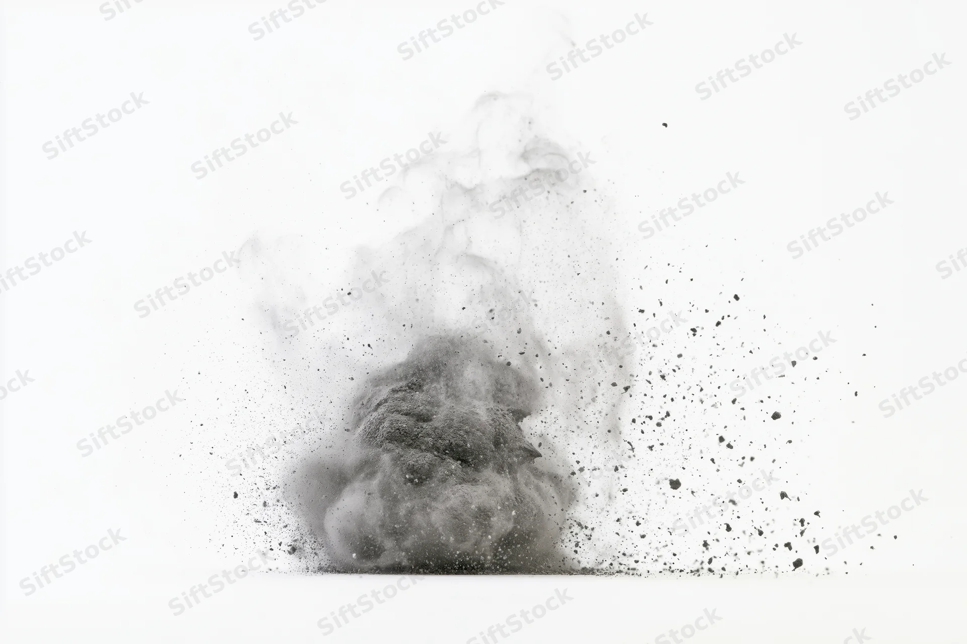 Gray powder exploding in mid-air against white background
