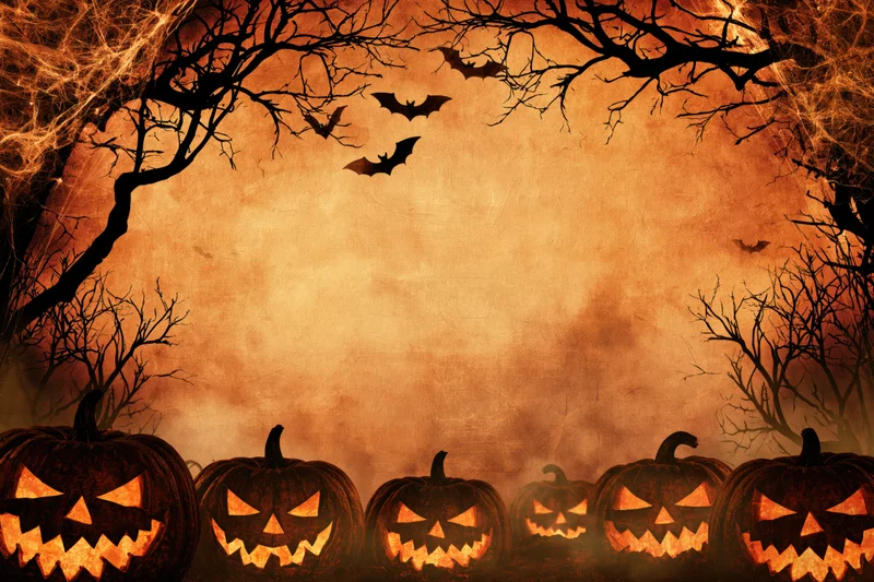 Carved jack-o-lanterns glowing at the base of bare trees with bats flying above in a spooky halloween scene