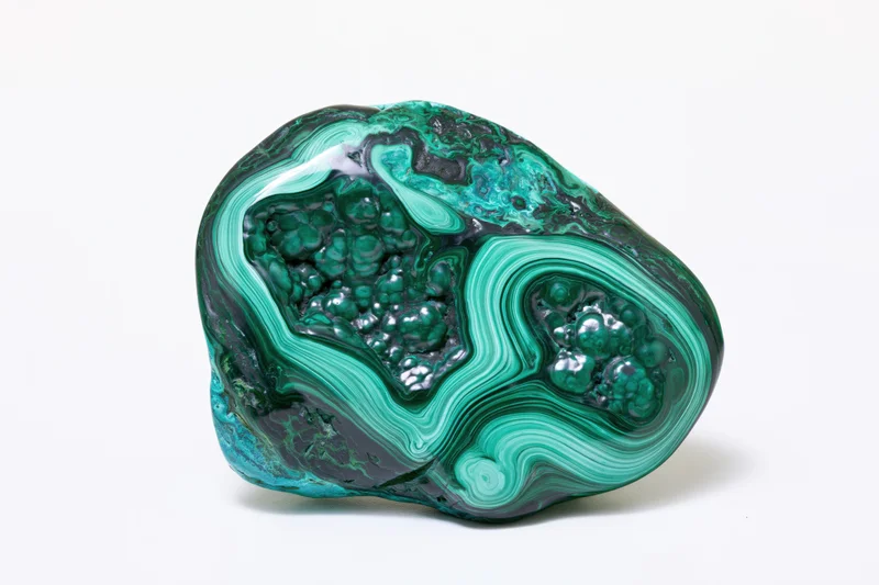 Polished malachite-chrysocolla mineral specimen with green and blue banding on white background