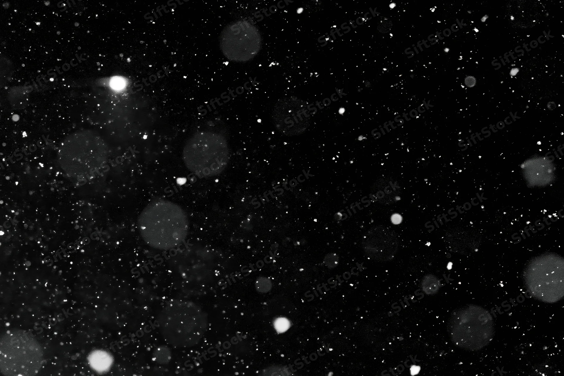 Falling snow against a black night sky