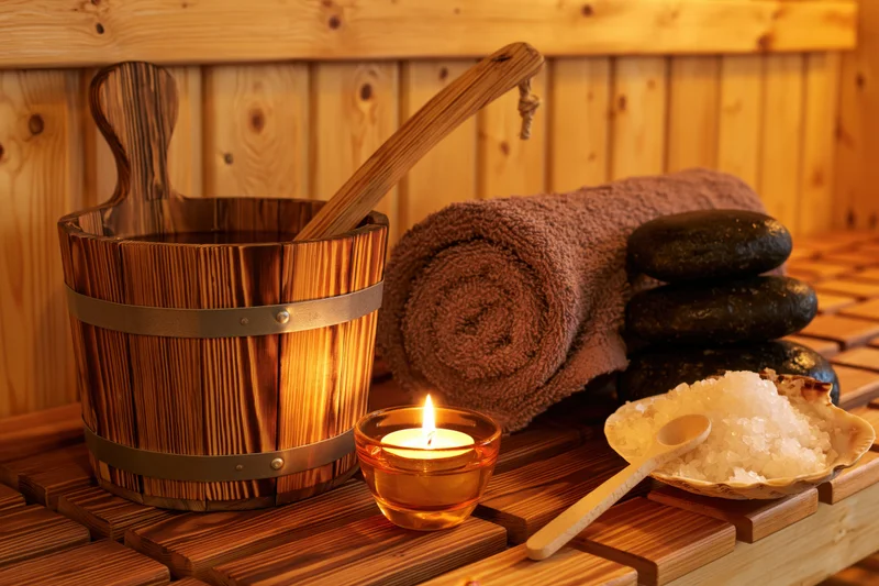 Sauna wellness accessories arranged on wooden bench slats