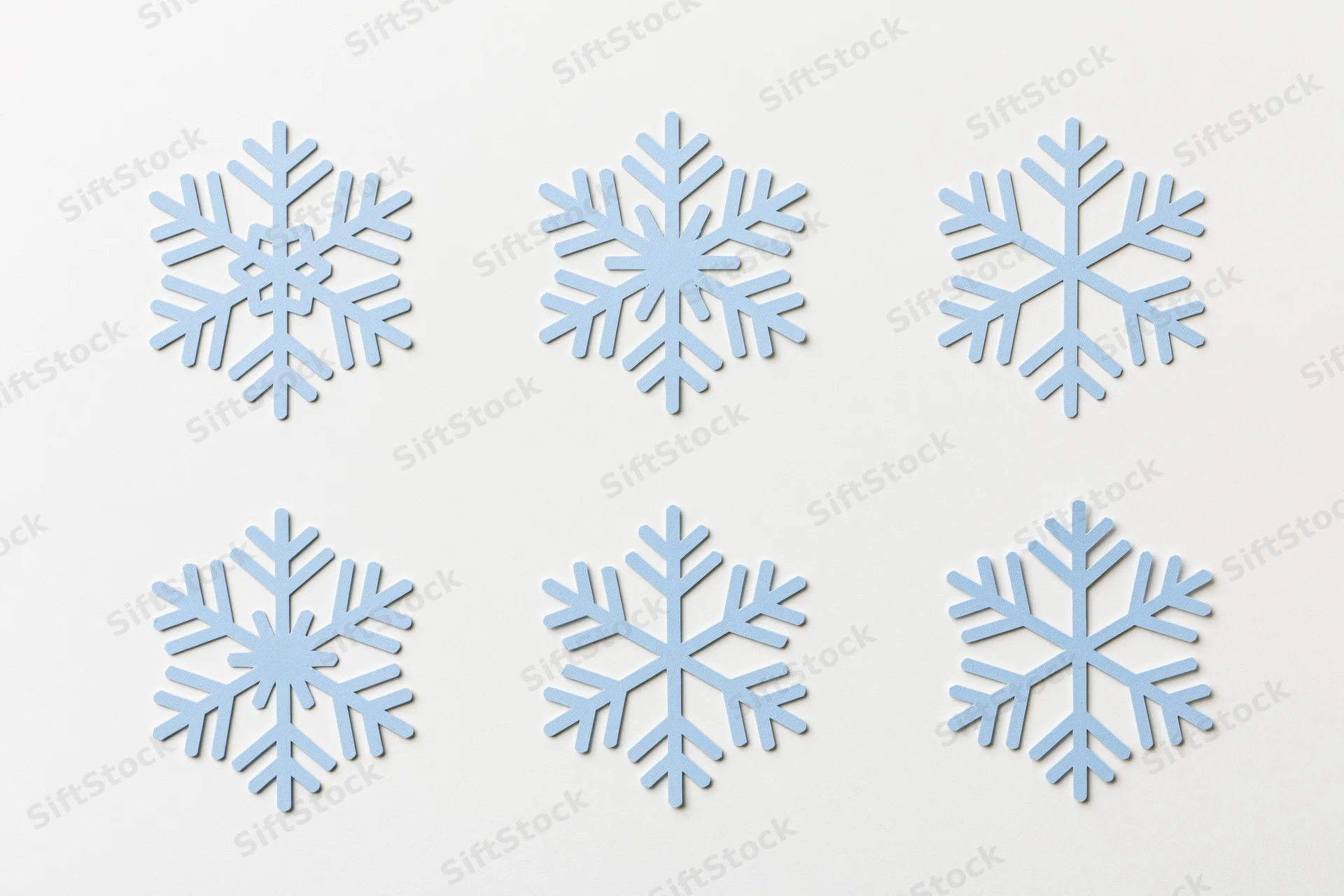 Six flat blue snowflake icons arranged in two rows on a white background