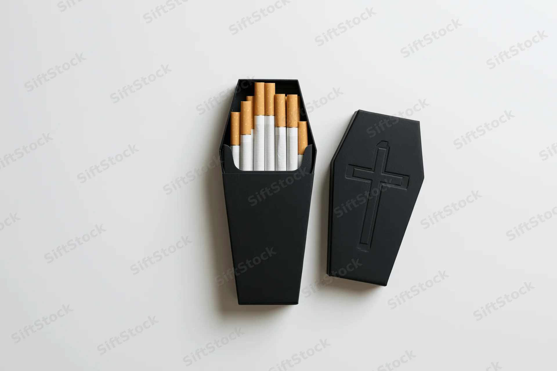 Coffin-shaped box filled with cigarettes on white background