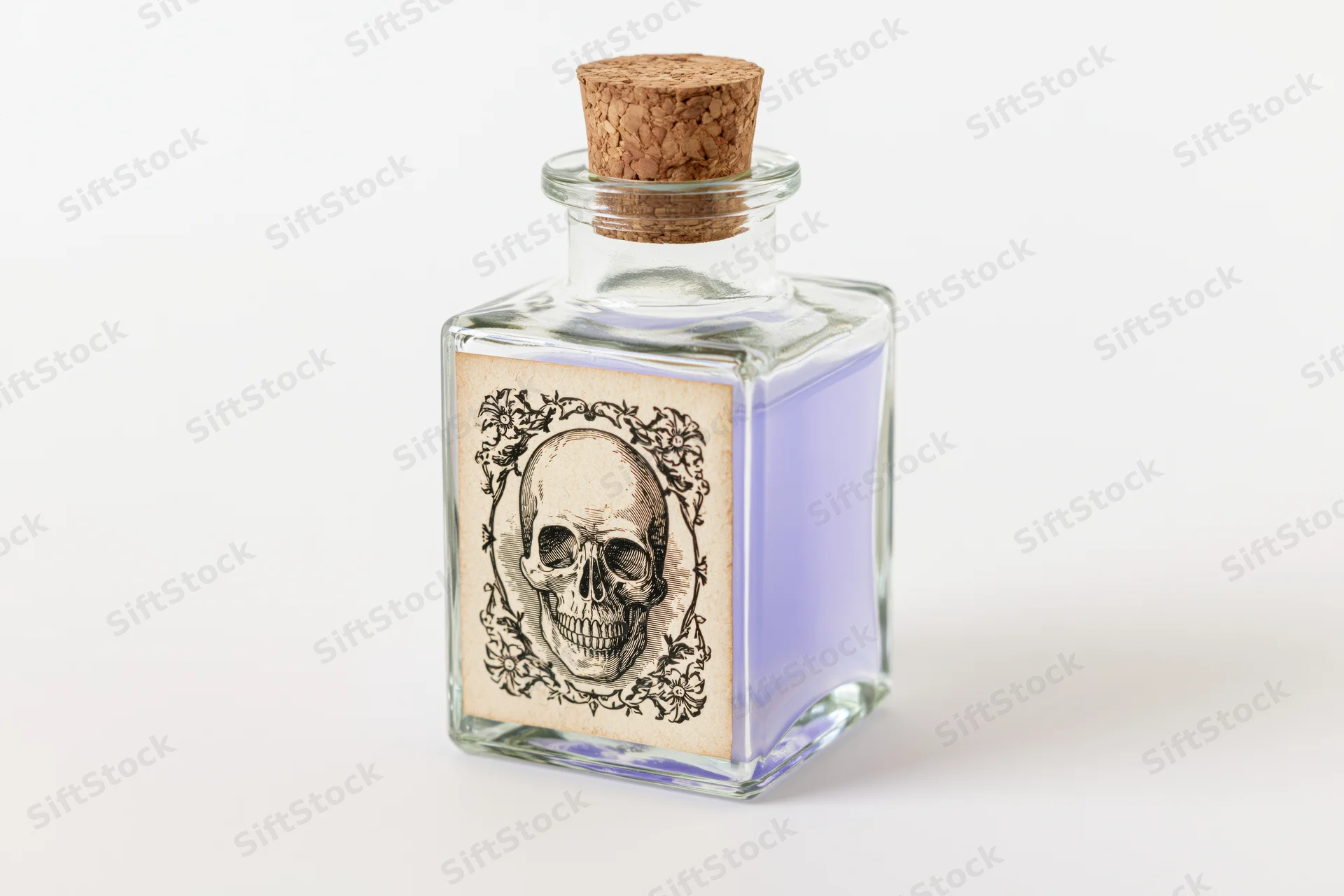 Square glass apothecary bottle with skull label and lavender liquid, corked, on white background