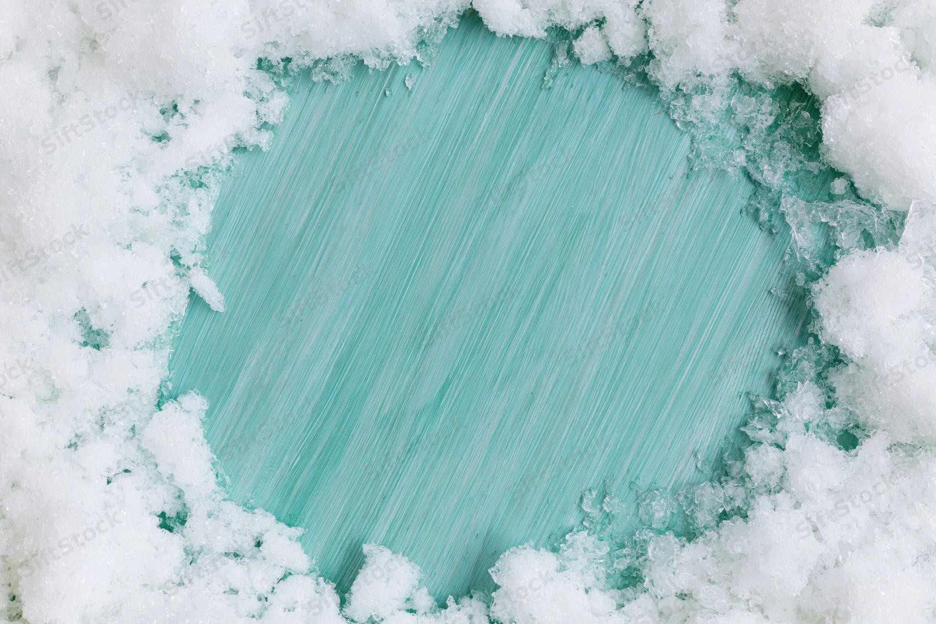 Snow cleared in a rough circle revealing a painted turquoise surface