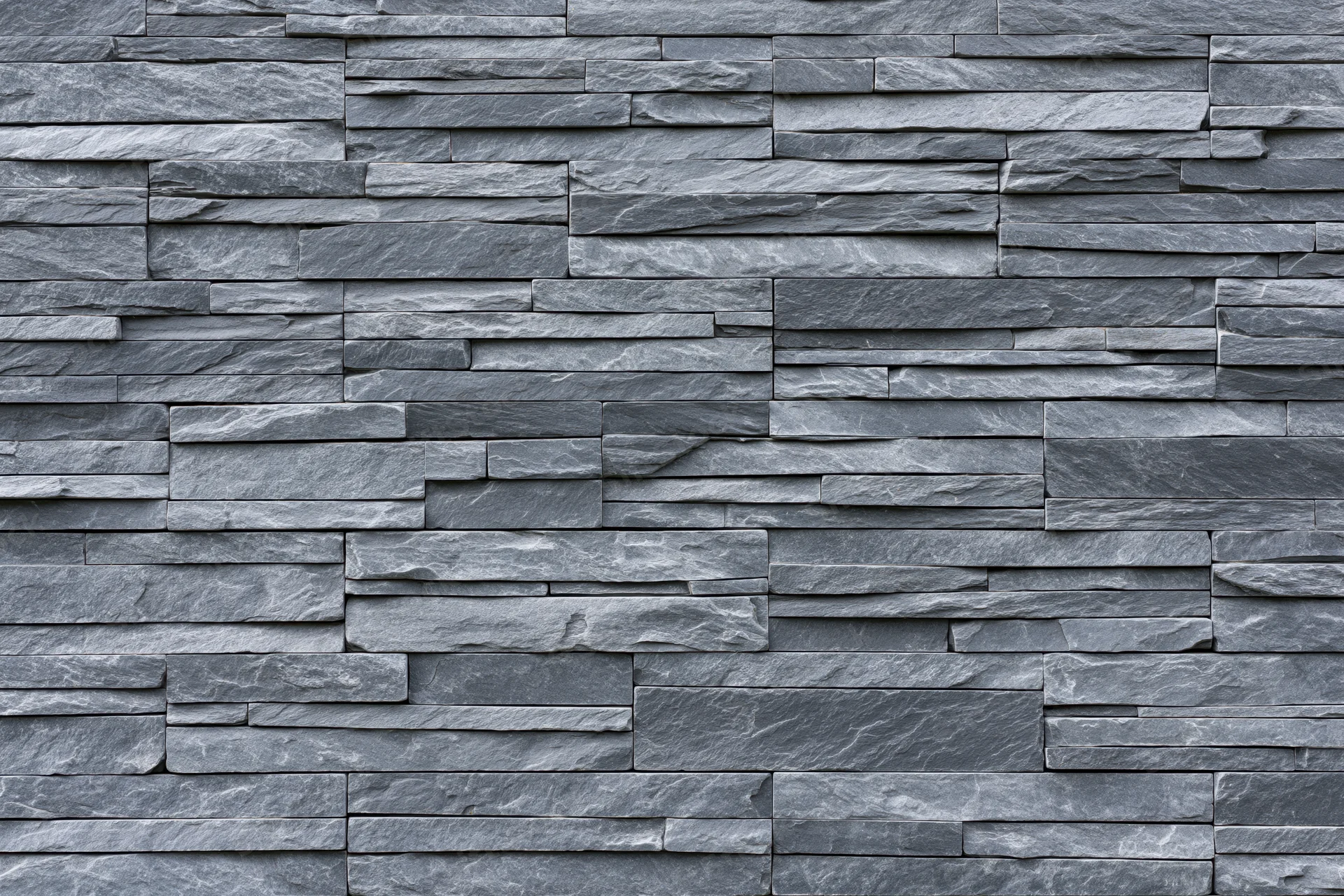 Stacked slate stone wall panel filling the frame with textured gray surface