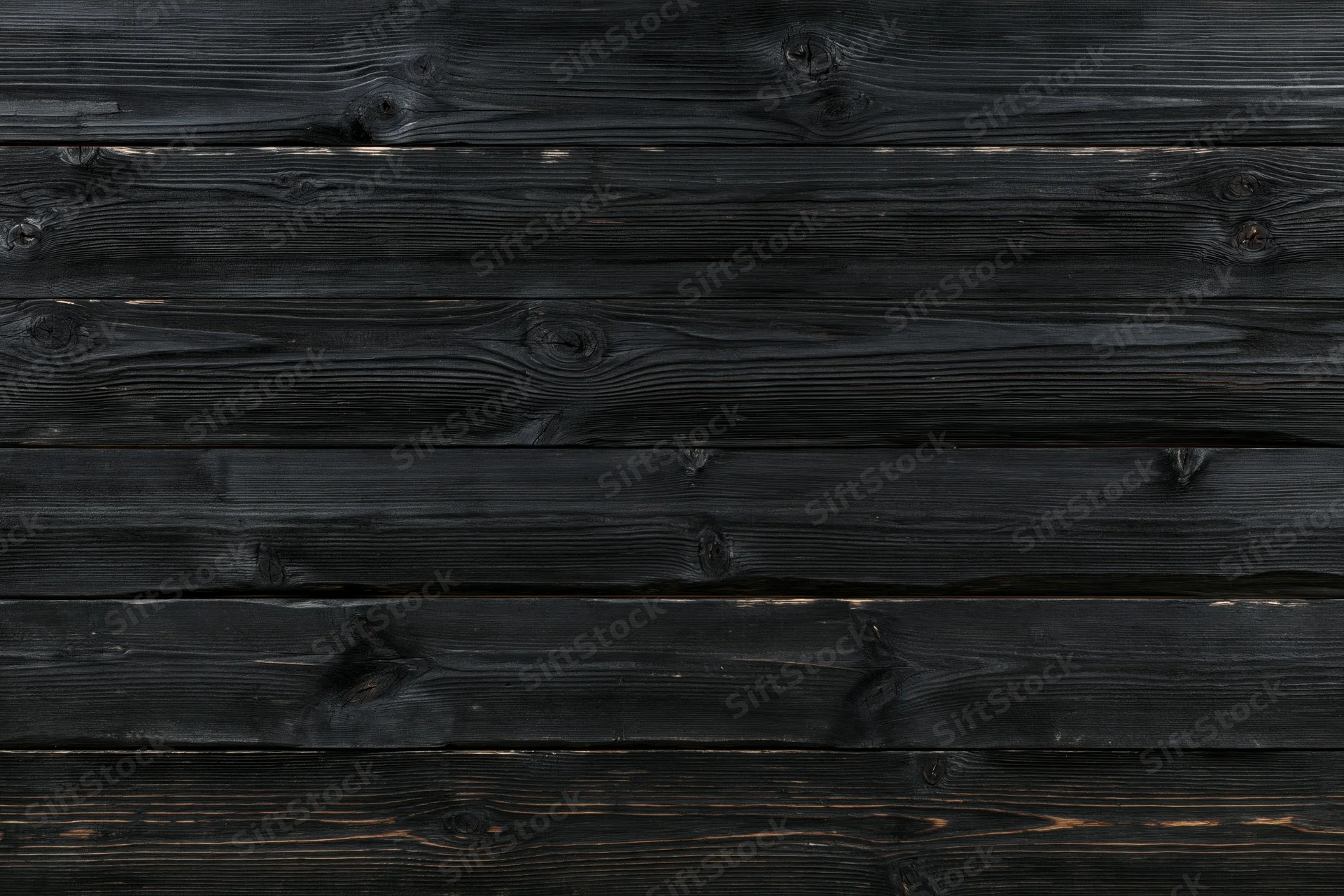 Horizontal dark charcoal wooden planks with visible grain and knots forming a weathered textured surface
