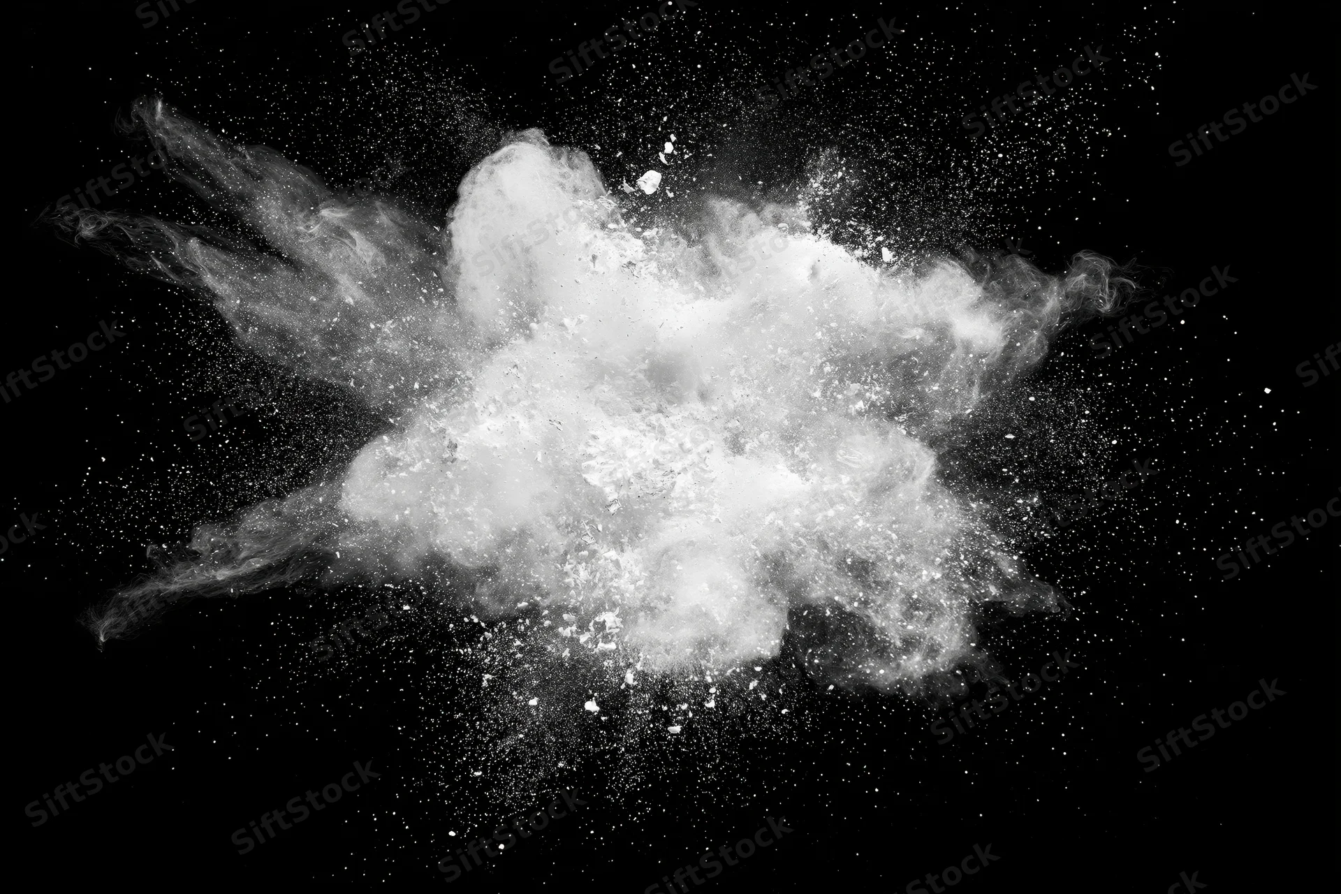 White powder exploding mid-air in burst pattern against black background