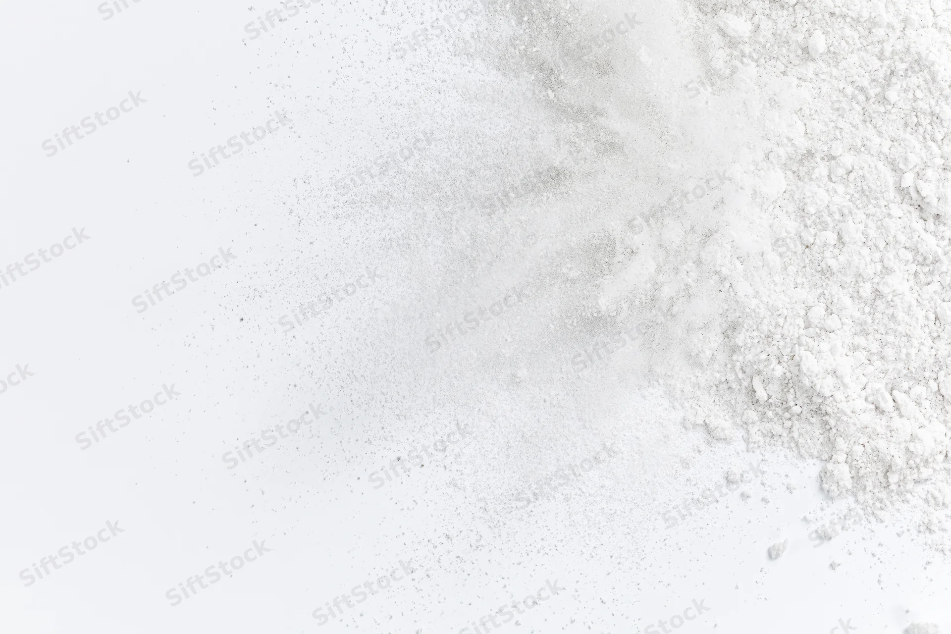 White powder bursting outward from lower right corner in frozen motion