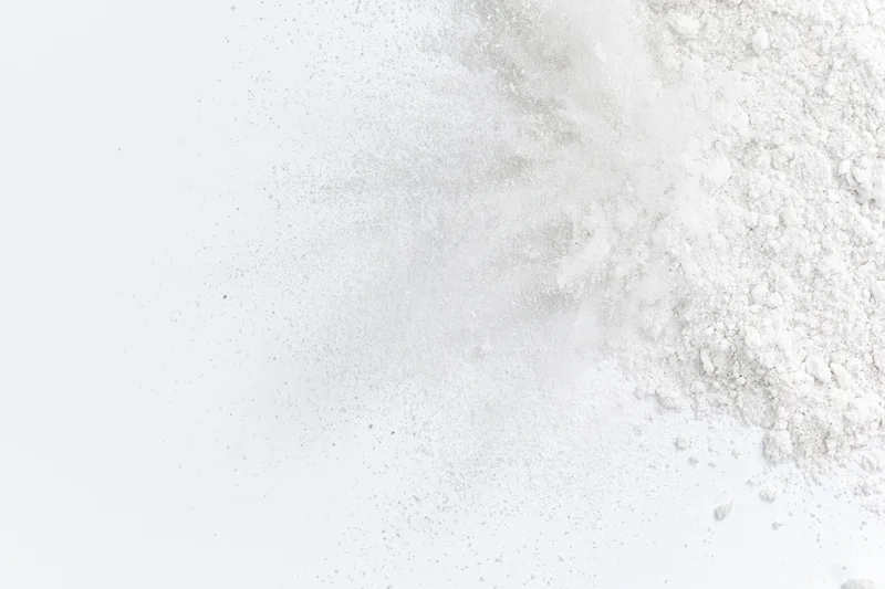 White powder bursting outward from lower right corner in frozen motion