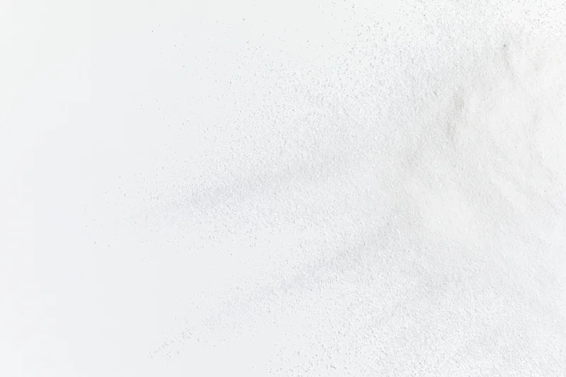 White powder bursting outward from lower right corner in frozen motion
