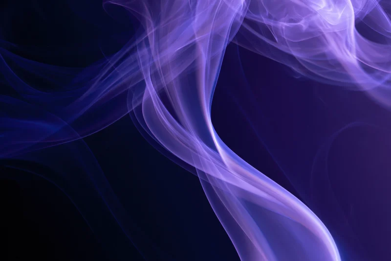 Wispy purple and blue smoke tendrils swirling against a dark background