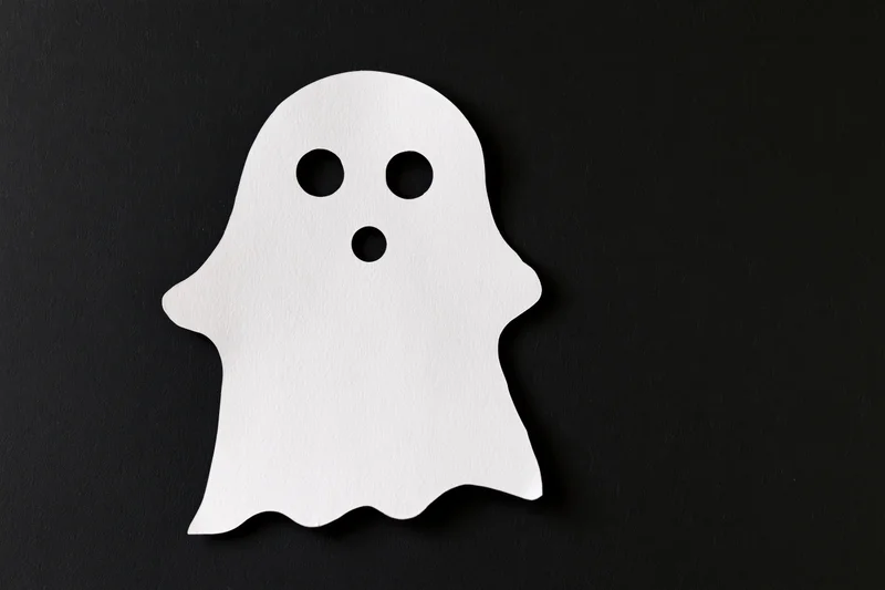 White paper ghost cutout on black background