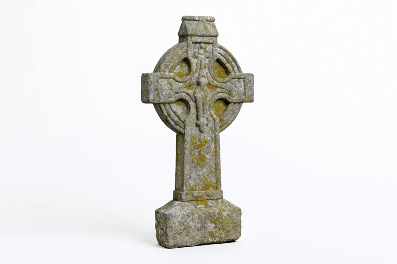 Ancient celtic stone cross gravestone with moss and lichen, isolated on white background