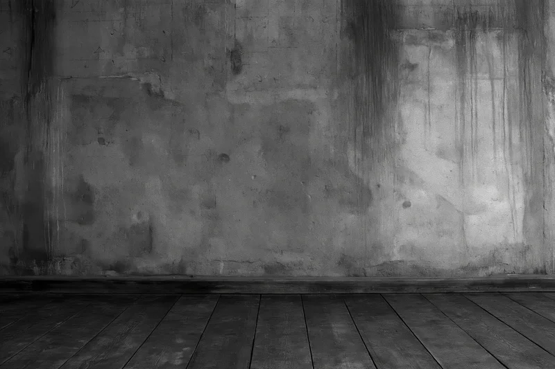 Empty industrial room with bare concrete wall and worn wooden floor