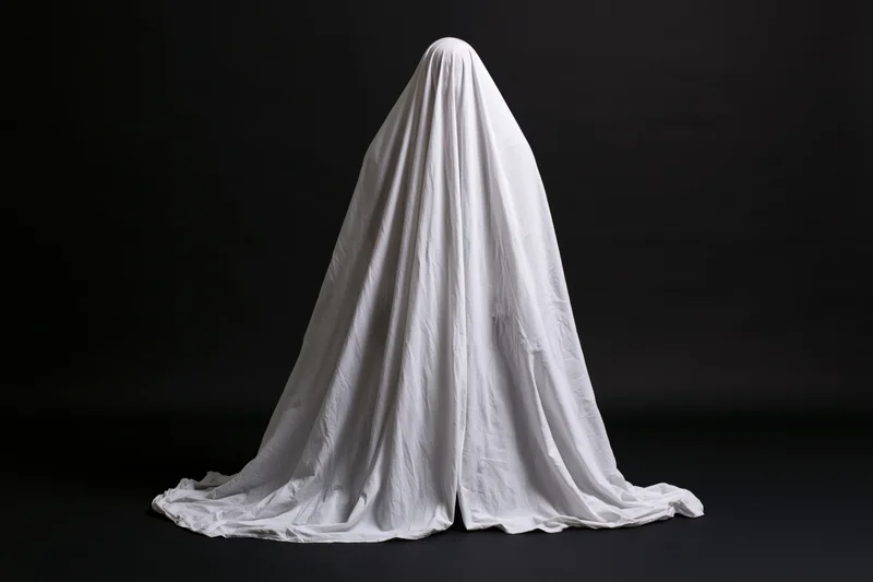 Ghost figure draped in white sheet against black background